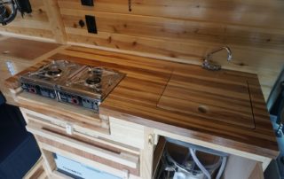 cutting board cover in ford transit 350 custom camper van conversion in golden, colorado