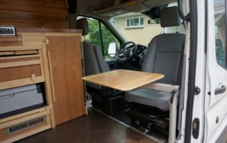 slide out table on ford transit 350 custom camper van conversion in golden, colorado