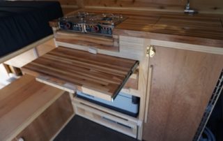 Cutting board on custom camper van conversion in golden, colorado